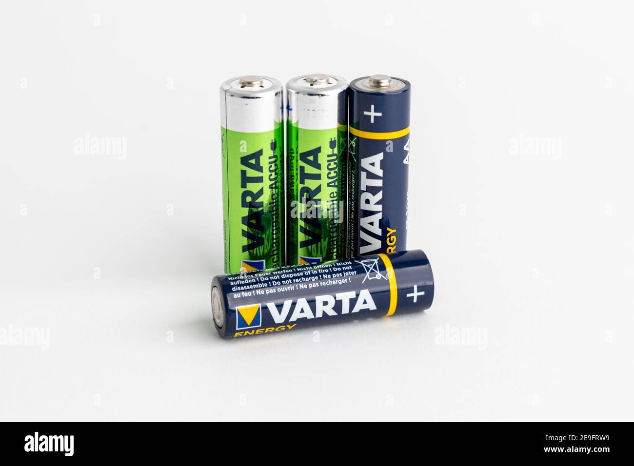 Blue varta batteries versus green rechargeable accus in front of a clean  white background. AA size energy storage for electric devices Stock Photo -  Alamy