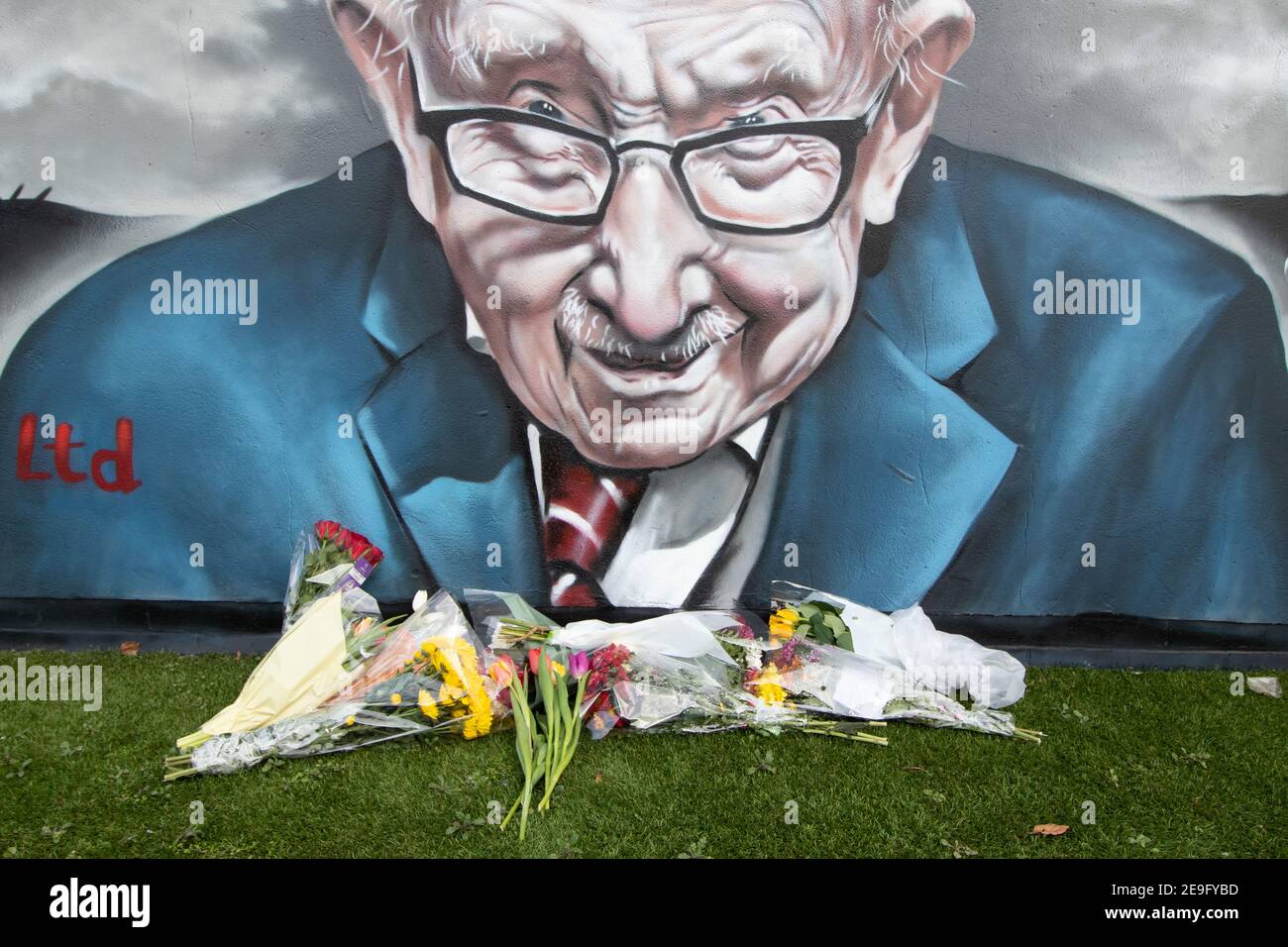 Flowers left under the mural of Sir Captain Tom Moore in Two Gates