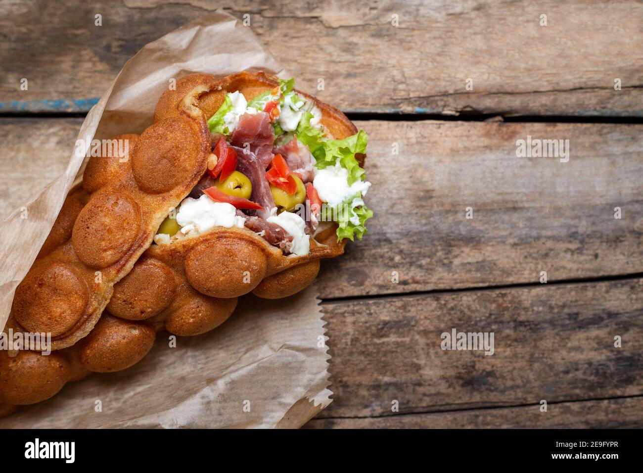 Top view of waffle stuffed with meat and olives Stock Photo