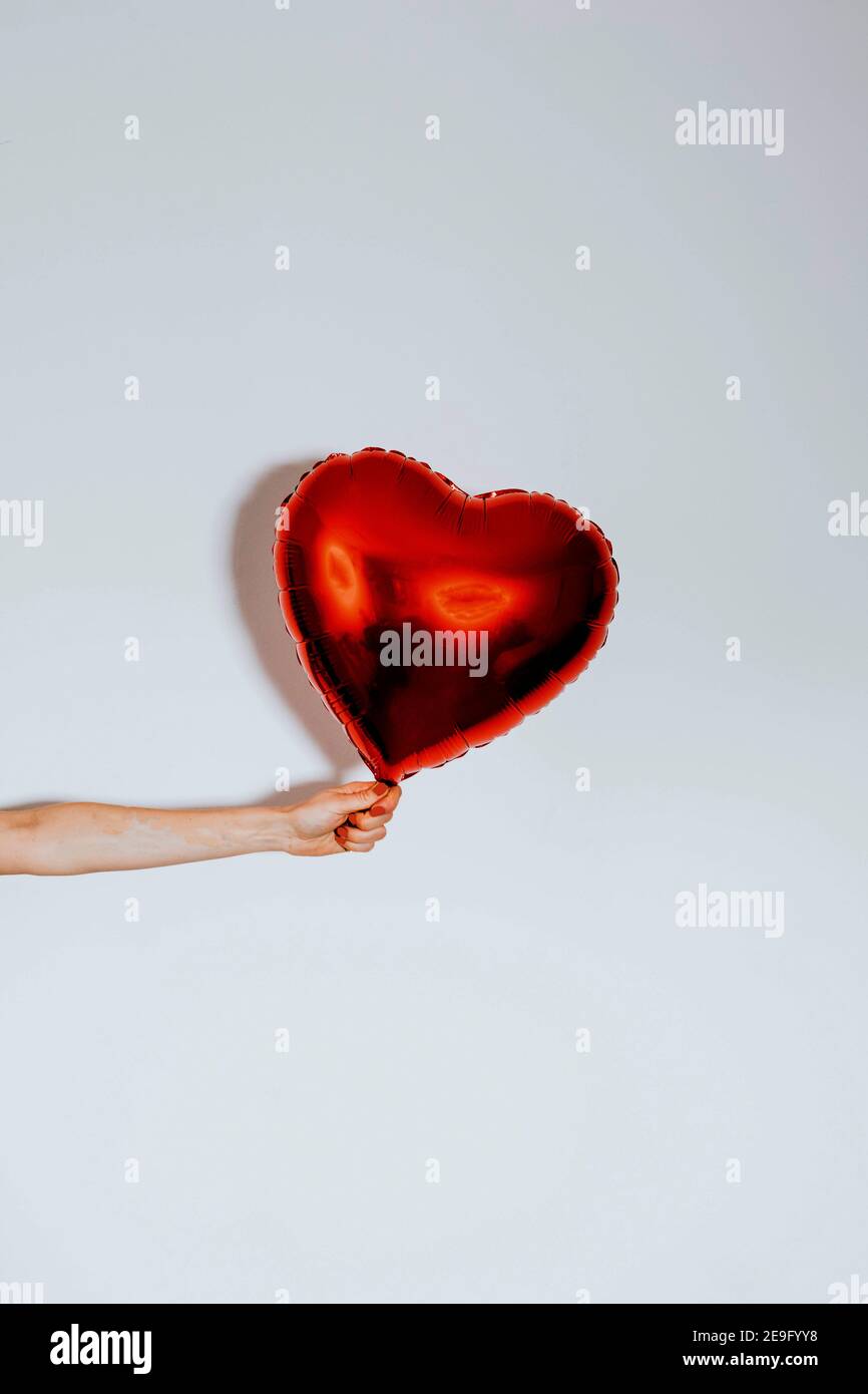 red heart shaped balloon for valentines day Stock Photo - Alamy