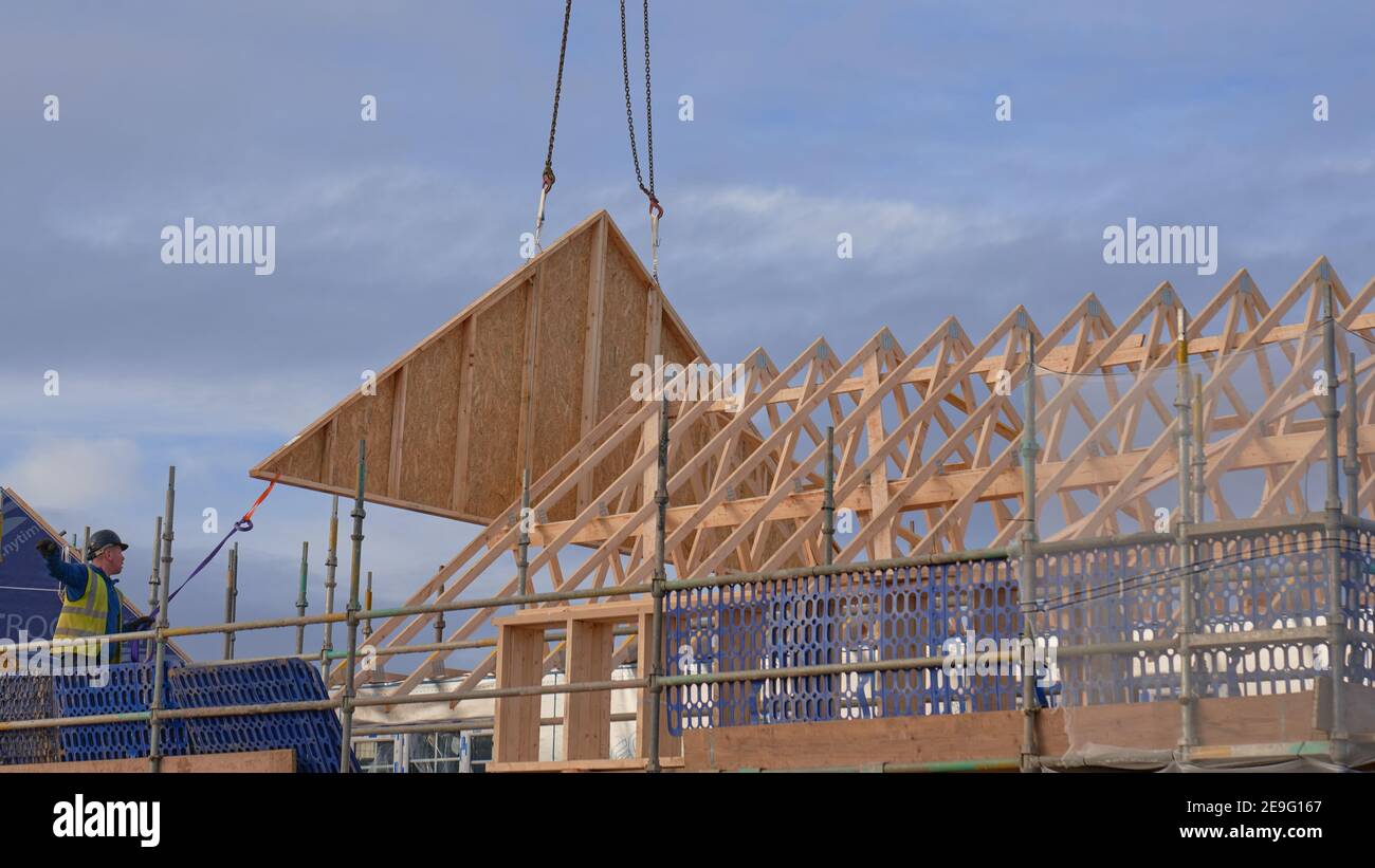 End roof truss being put into place with a crane Stock Photo