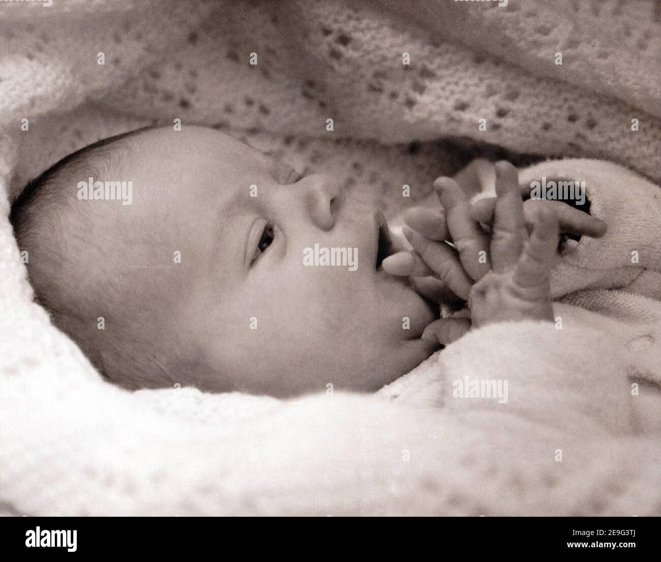 Baby wrapped in blanket hi-res stock photography and images - Alamy