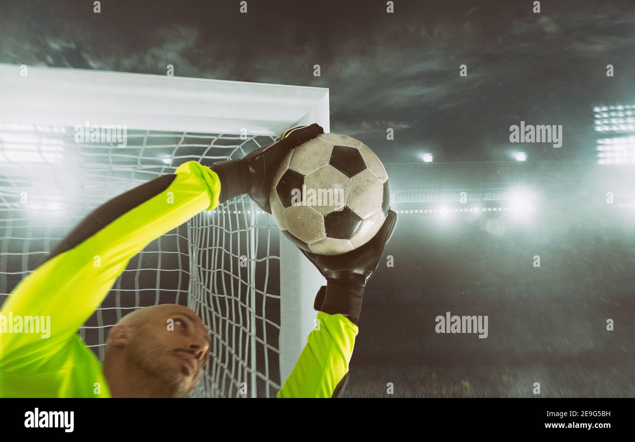 Close up of a soccer goalkeeper saving the ball at the corner of the goalposts Stock Photo