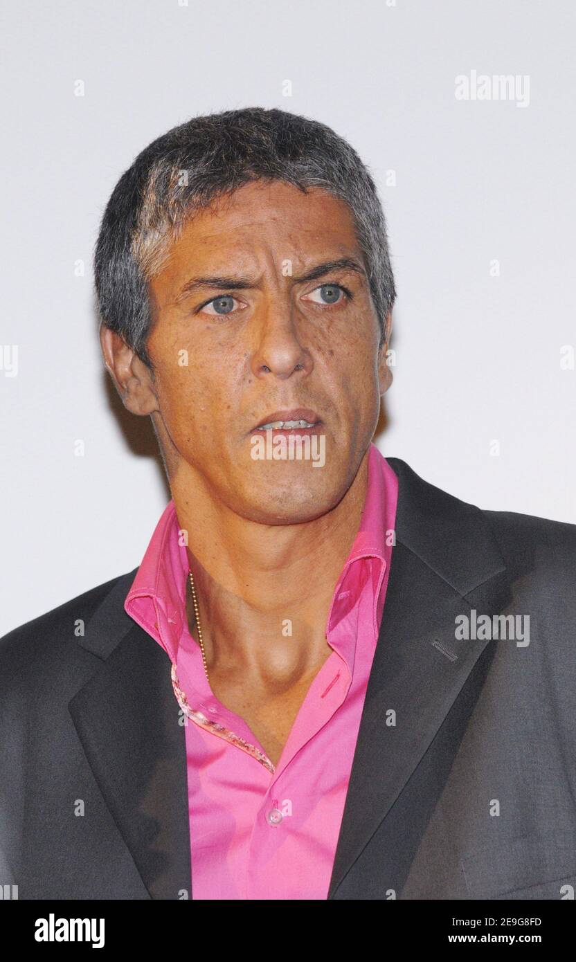 Cast member Samy Naceri poses for pictures as he arrives to the