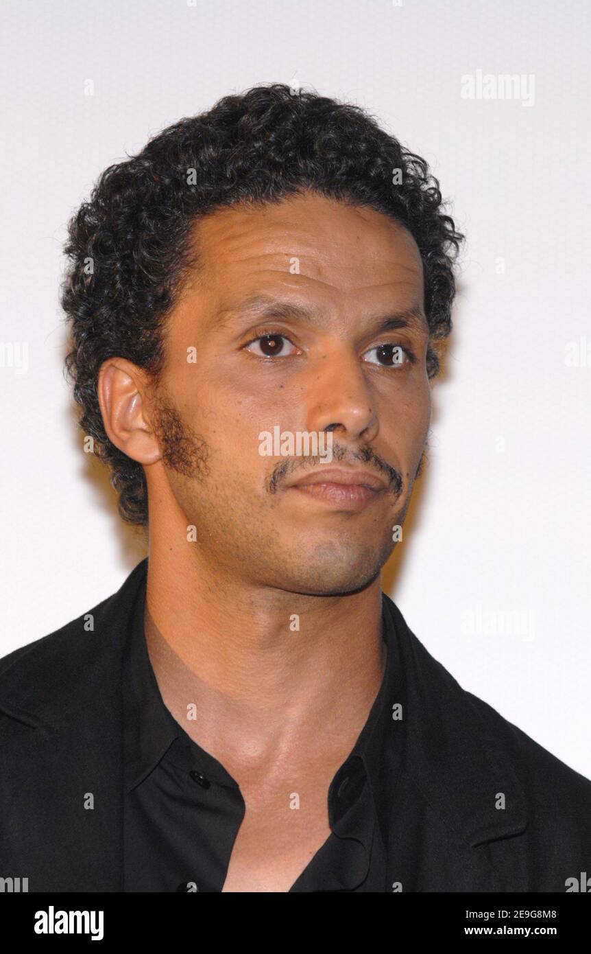 Cast member Sami Bouajila poses for pictures as he arrives to the
