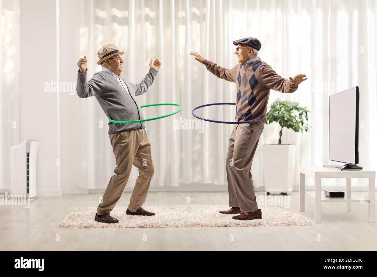 https://c8.alamy.com/comp/2E9GC06/funny-elderly-men-spinning-hula-hoops-inside-a-room-2E9GC06.jpg