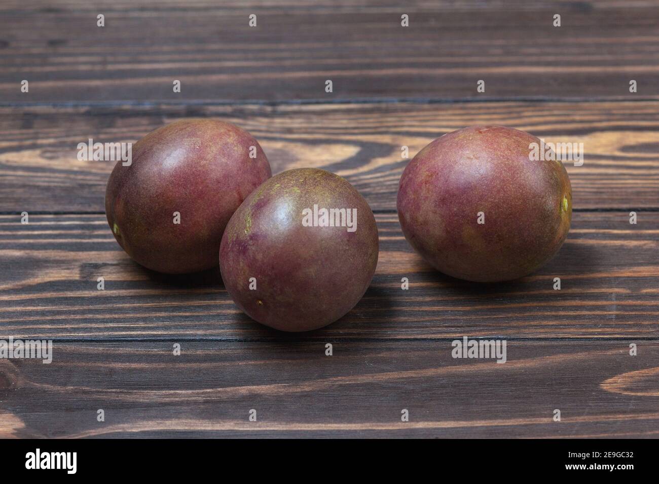 Ripe passionfruit fruit, lie on a background of wooden boards. High quality photo Stock Photo