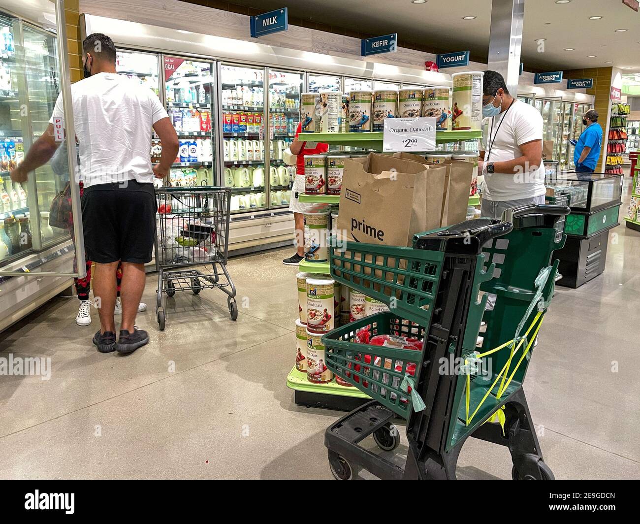 Orlando, FL USA - January 24, 2021: Amazon Prime Fresh employees shopping at a Whole Foods grocery store selecting food for for people to have deliver Stock Photo