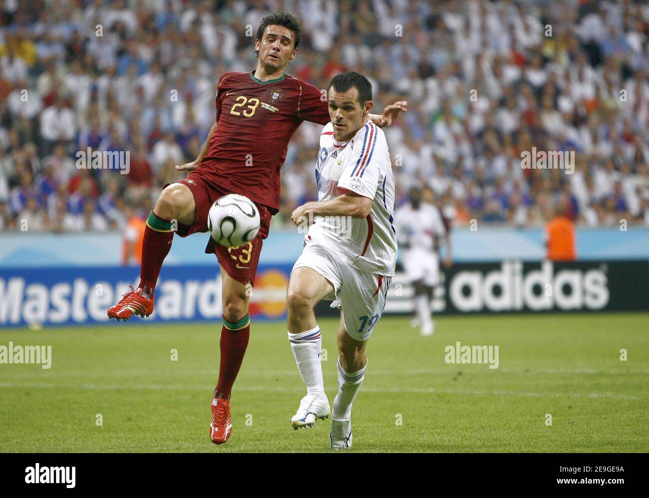 France's Willy Sagnol and Portugal's Postiga Helder battle for the ball during the World Cup 2006, semi-final, France vs Portugal at the Allianz-Arena stadium in Munich, Germany on July 5, 2006. France won 1-0 and advanced to the final. Photo by Christian Liewig/ABACAPRESS.COM Stock Photo