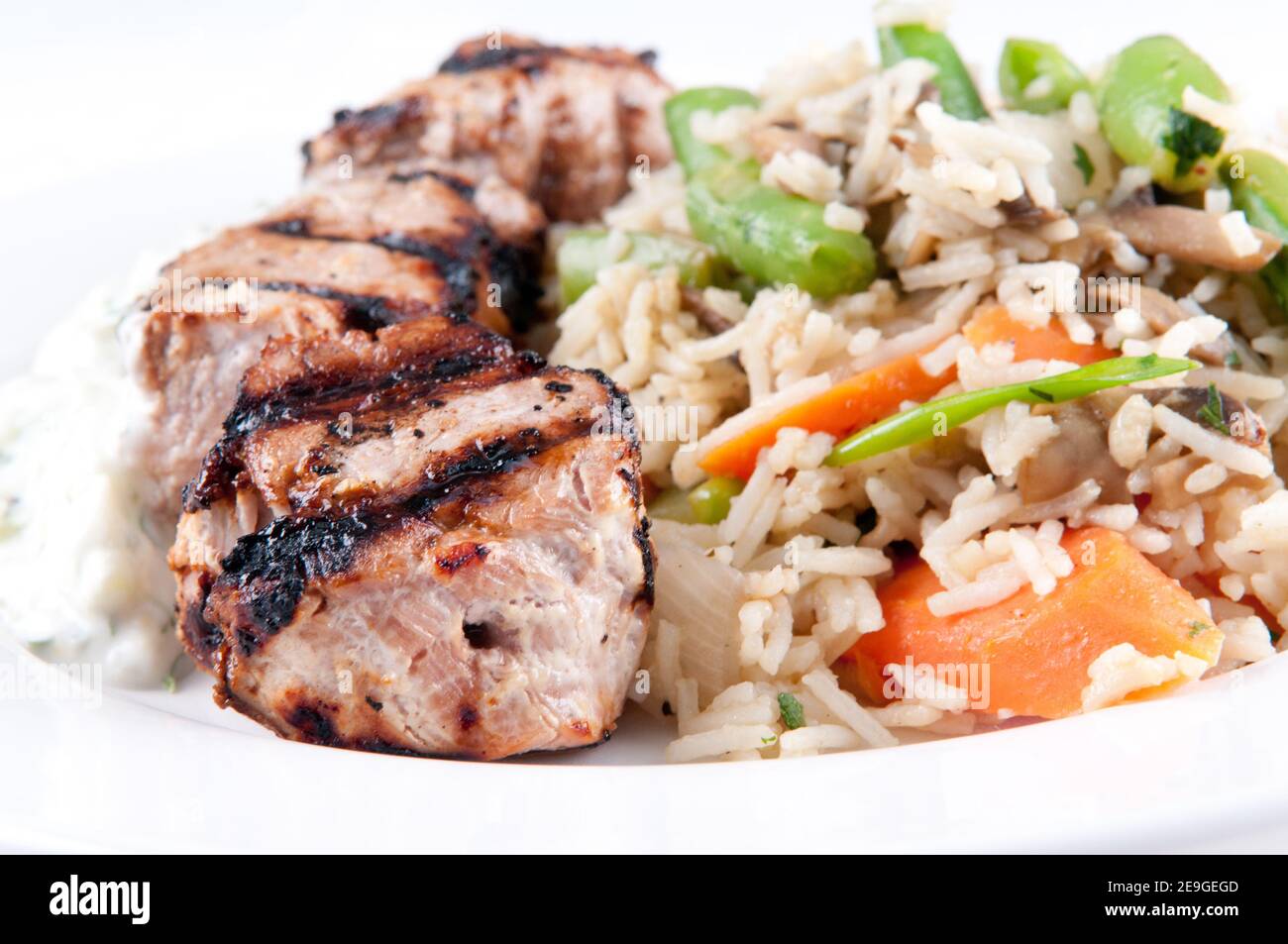 homemade tzatziki with grilled lamb kabobs, rice and vegetables Stock