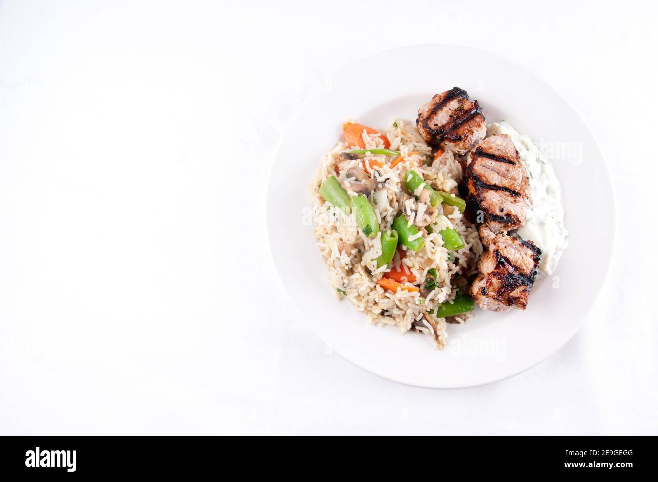 homemade tzatziki with grilled lamb kabobs, rice and vegetables Stock