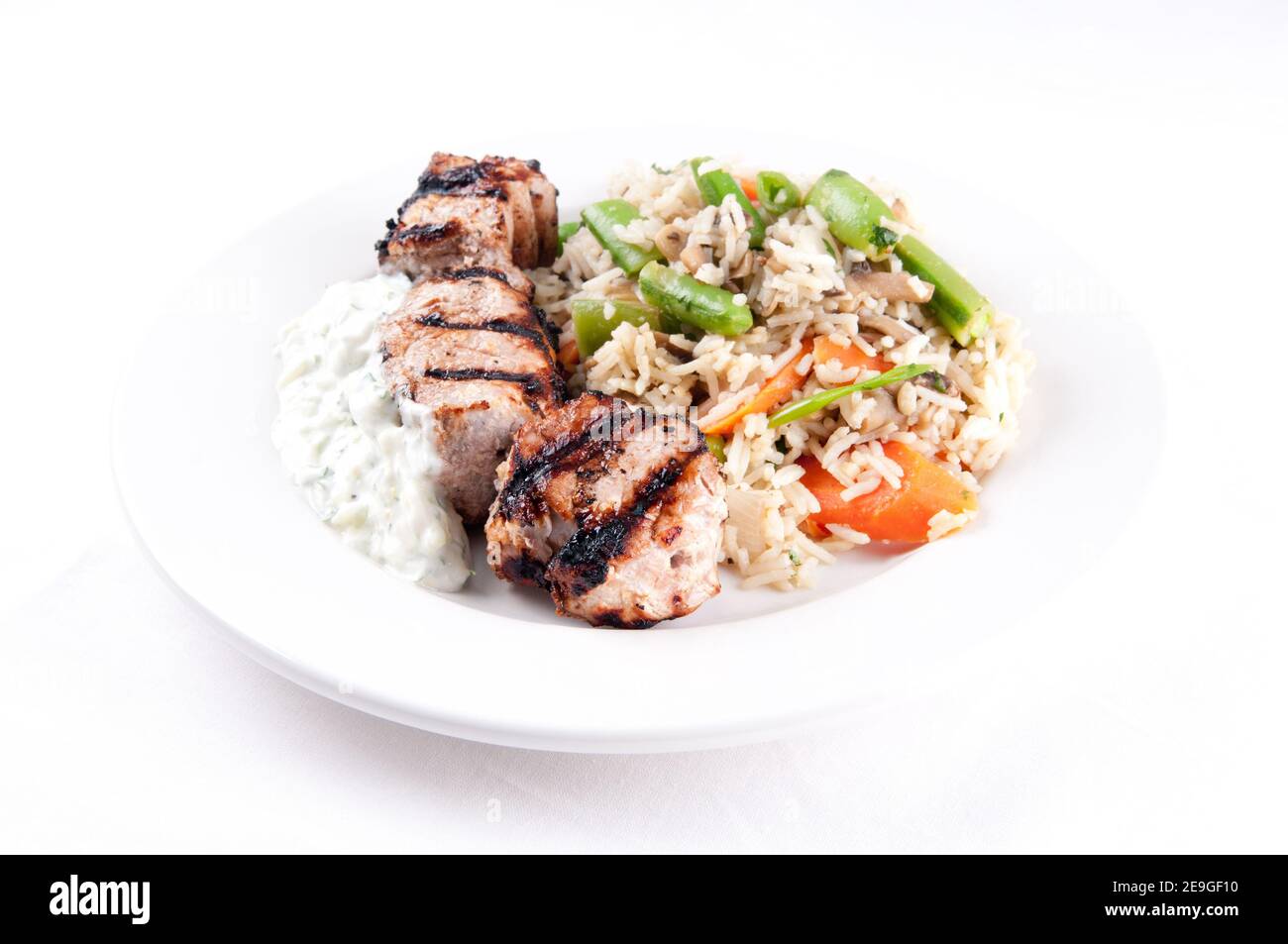 homemade tzatziki with grilled lamb kabobs, rice and vegetables Stock