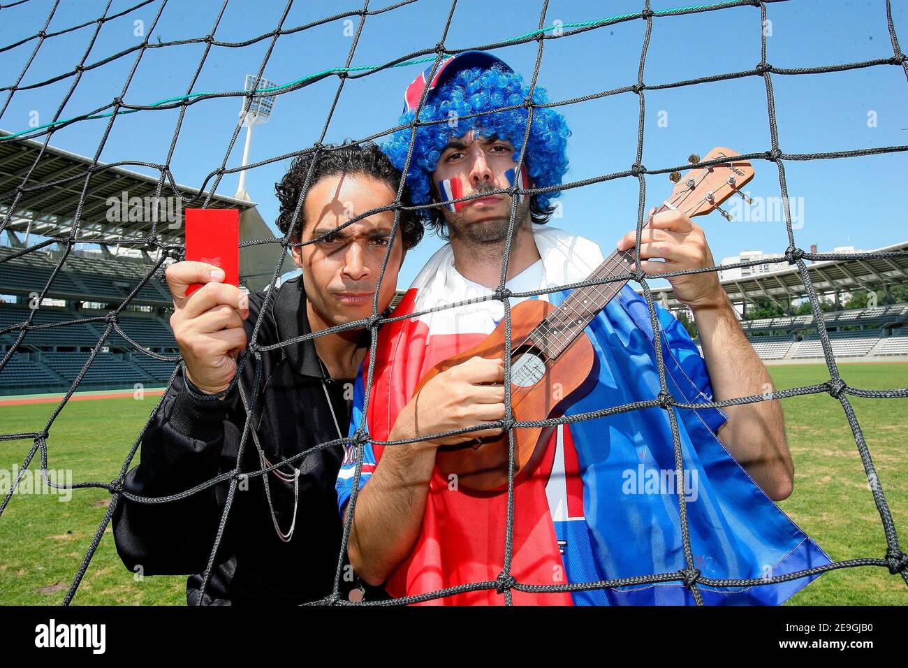 French singer Franck Lascombes (Glasses and black referre costume) is singing on the set of the videoclip 'Coup de Boule' (Headbutt) at Charlety Stadium, Paris, France on July 15, 2006.He is playing in the clip with 'Plage Records' President Sebastien Lipszyc (Blue Hair), owner of the music. This videoclip is a parody of France's Zinedine Zidane headbutt against Italy's Marco Materazzi which led to Zidane being sent-off during the FIFA World Cup Final at the Olympiastadion in Berlin. Photo by Mehdi Taamallah/ABACAPRESS.COM Stock Photo