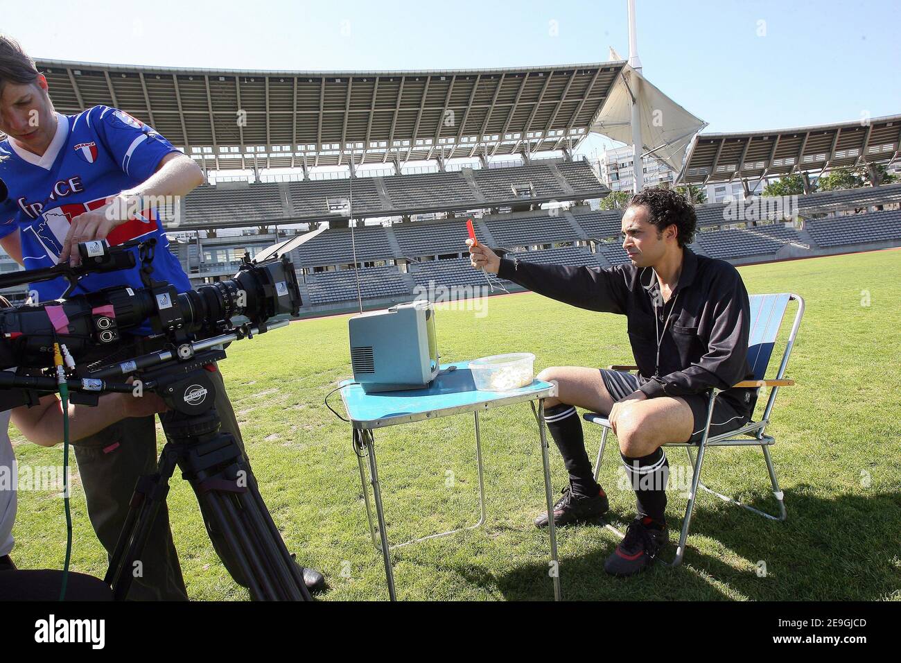 French singer Franck Lascombes (Glasses and black referre costume) is singing on the set of the videoclip 'Coup de Boule' (Headbutt) at Charlety Stadium, Paris, France on July 15, 2006.He is playing in the clip with 'Plage Records' President Sebastien Lipszyc (Blue Hair), owner of the music. This videoclip is a parody of France's Zinedine Zidane headbutt against Italy's Marco Materazzi which led to Zidane being sent-off during the FIFA World Cup Final at the Olympiastadion in Berlin. Photo by Mehdi Taamallah/ABACAPRESS.COM Stock Photo