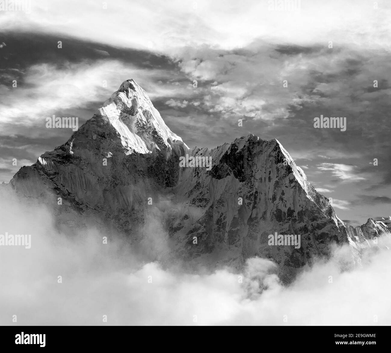 Black and white view of Ama Dablam with and beautiful clouds - Sagarmatha national park - Khumbu valley - Trek to Everest base cam - Nepal Stock Photo