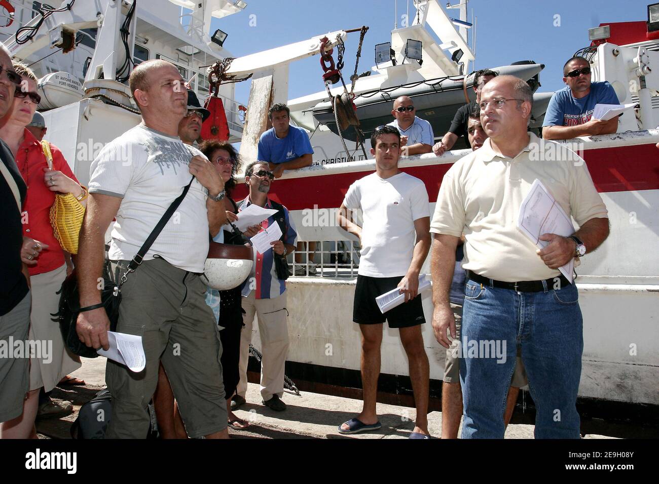 Mourad Kahoul, (yellow shirt) president of the Tuna fishermen of Mediteranean sea's association declares his opposition at the venue of Rainbow Warrior II in Marseille's port on 22 August, 2006. Since two days fishermen and authorities running the port in France's southern city of Marseille are blocking the arrival of a Greenpeace ship Rainbow Warrior II due this week amid a row over a campaign to save dwindling red tuna stocks. Photo by Gerald Holubowicz/ABACAPRESS.COM Stock Photo