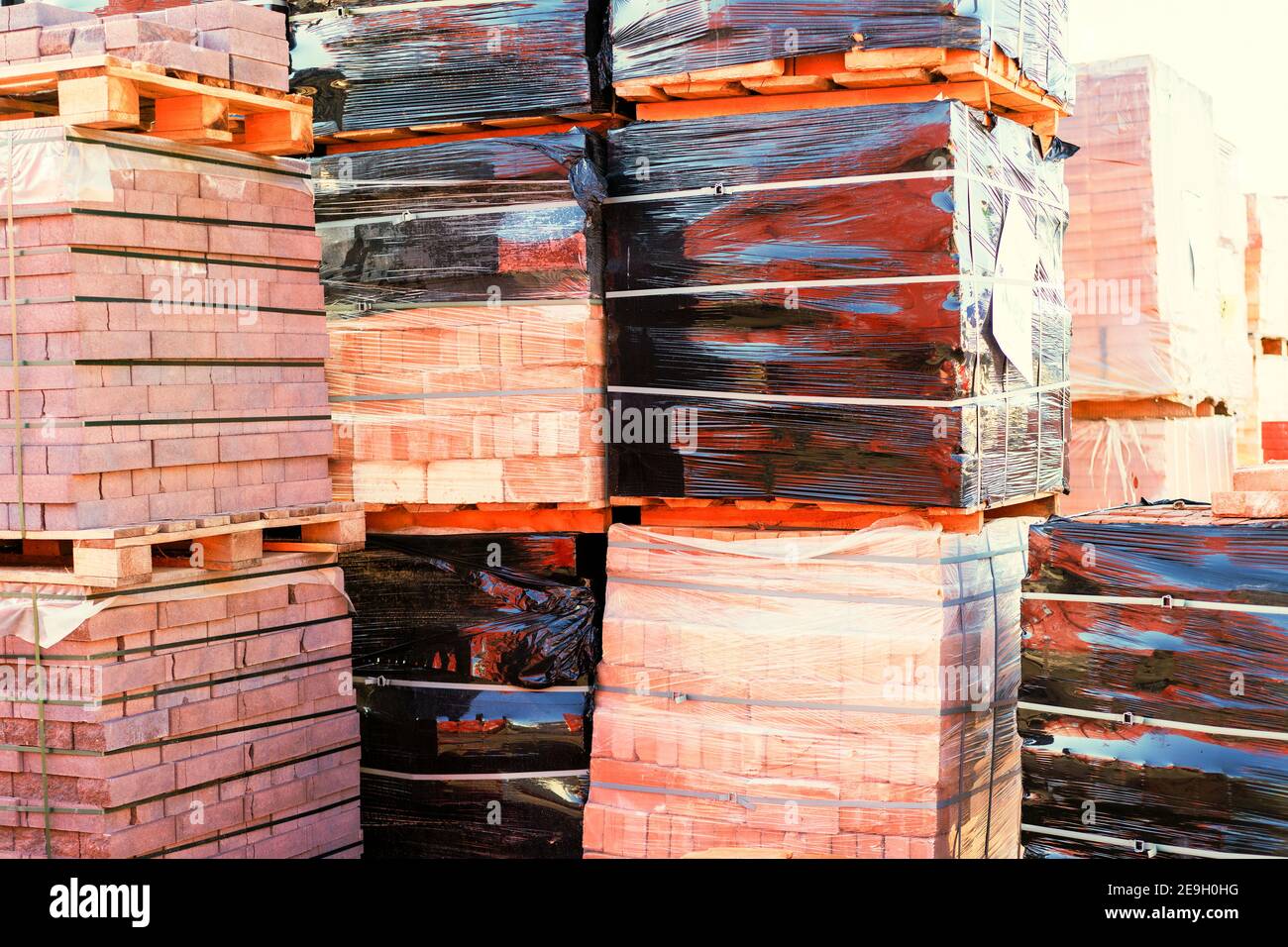 Pallets with red bricks outdoors. Building materials wholesale. pallets