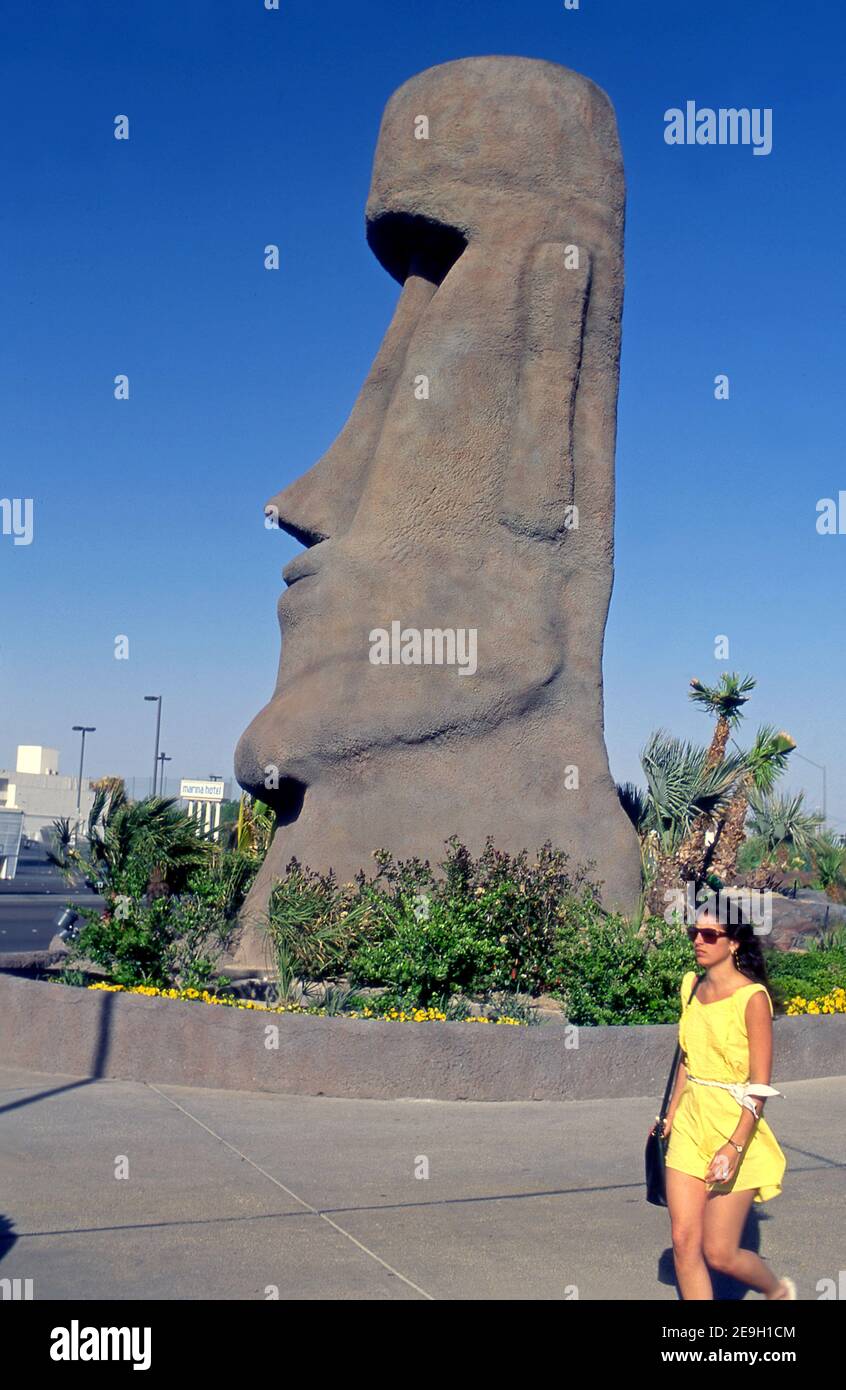 A woman wlaks past a large Tiki figure outside the Tropicana Hotel and Casino in Las Vegas, Nevada, Stock Photo