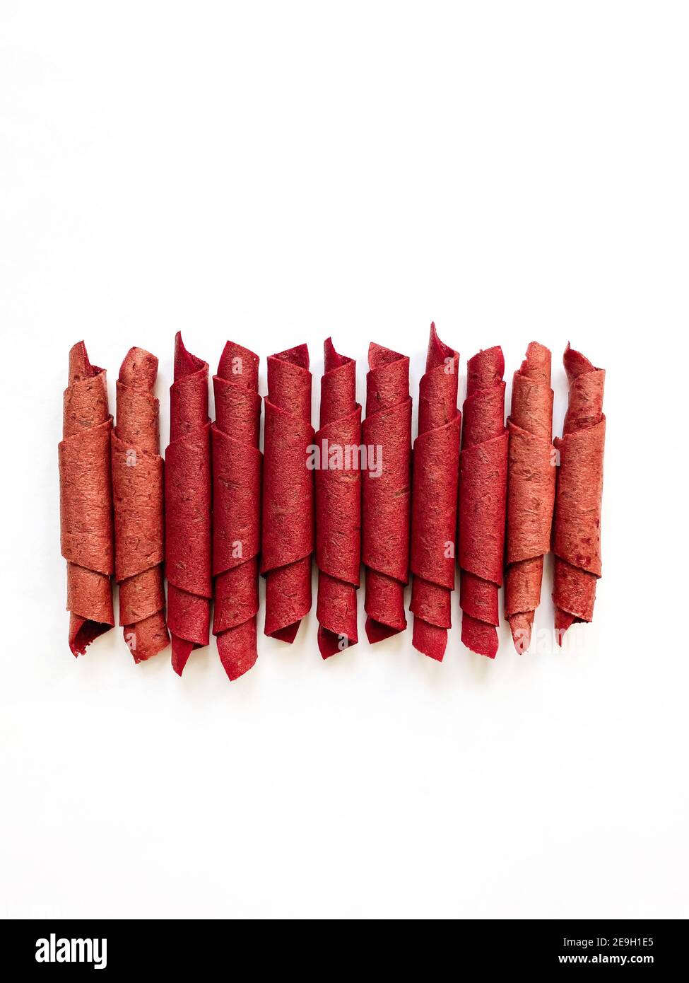 Red fruit leather rolls isolated on white. Fruit candy - pastille. Top view Stock Photo