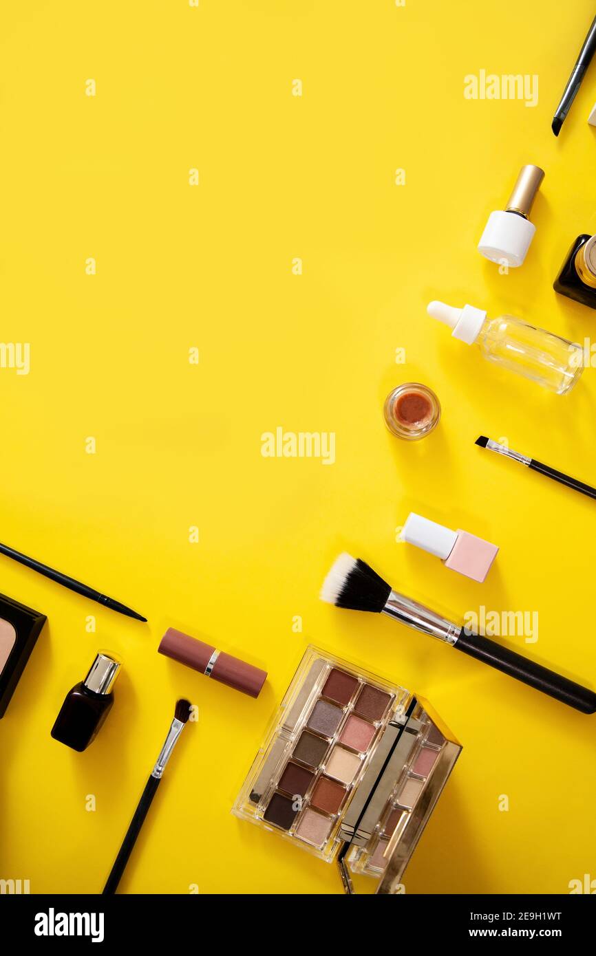 Make up cosmetics flat lay on yellow background. Stock Photo