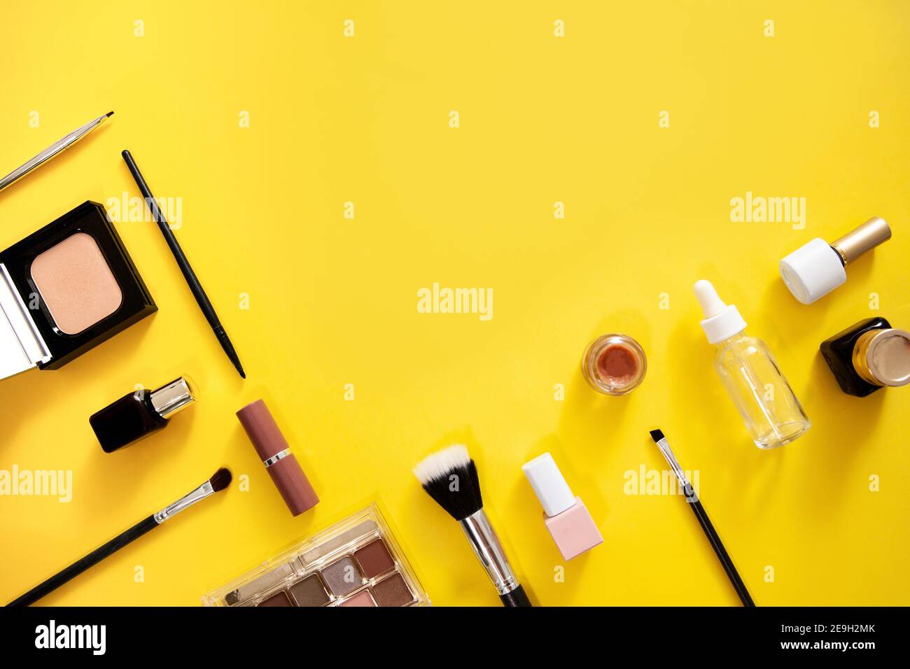 Make up cosmetics flat lay on yellow background. Stock Photo