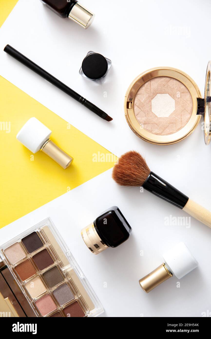 Make up cosmetics flat lay on yellow background. Stock Photo