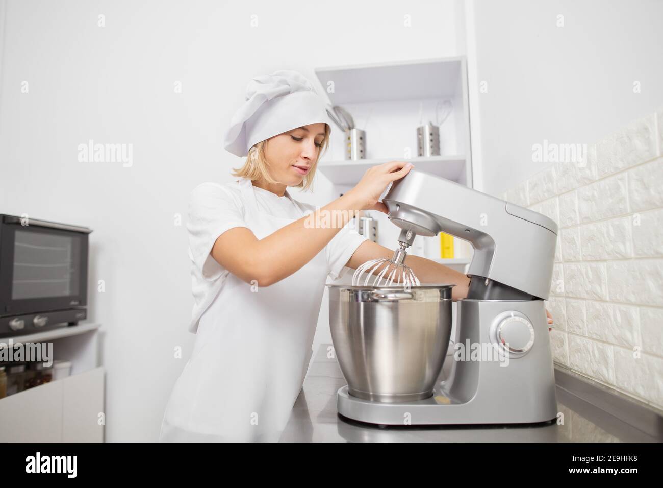 Cooking, baking, confectionery concept. Pretty young woman confectioner