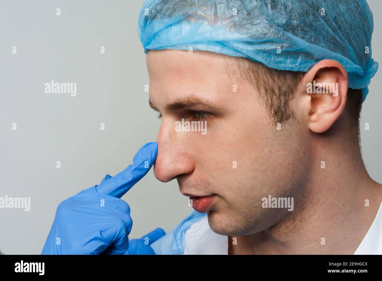 Facebuilding. Septoplasty and nose rhinoplasty. Doctor touches man nose on consultation