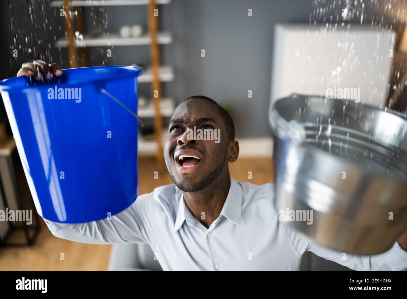 Leaking Water From Ceiling In Apartment. Holding Bucket Stock Photo Alamy