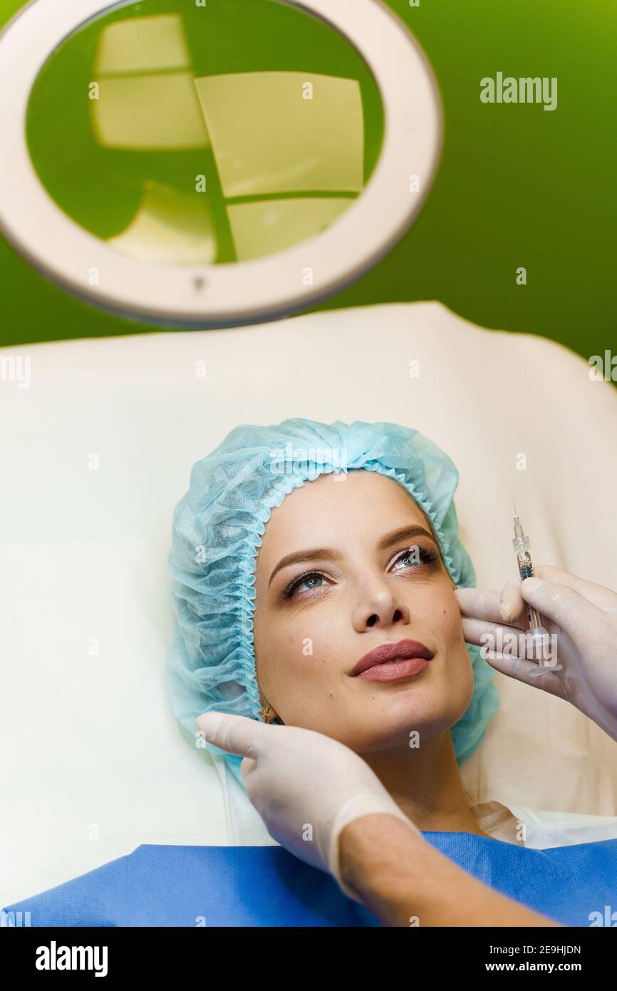 Close-up filler injection in cheekbones. ?ontour plastic for correcting ...