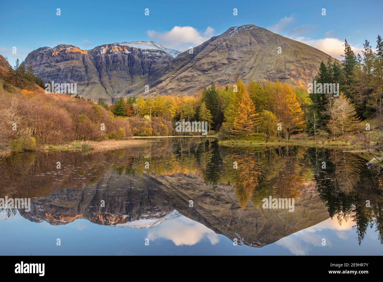 Glencoe, Scotland: A small pond with fall reflections and the mountains of Glen Coe Stock Photo