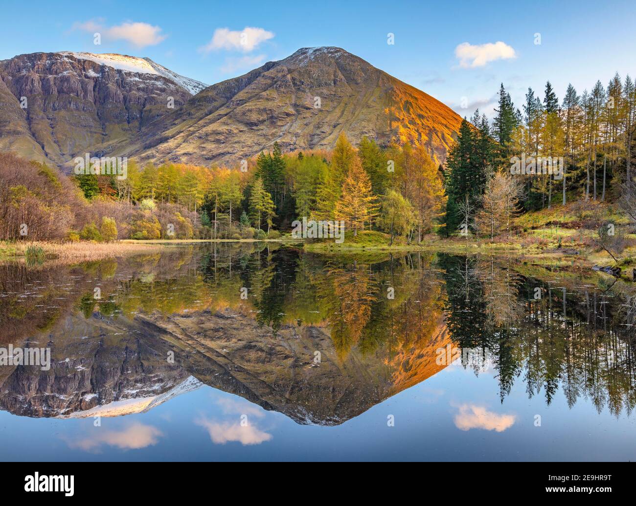 Glencoe, Scotland: A small pond with fall reflections and the mountains of Glen Coe at sunset Stock Photo