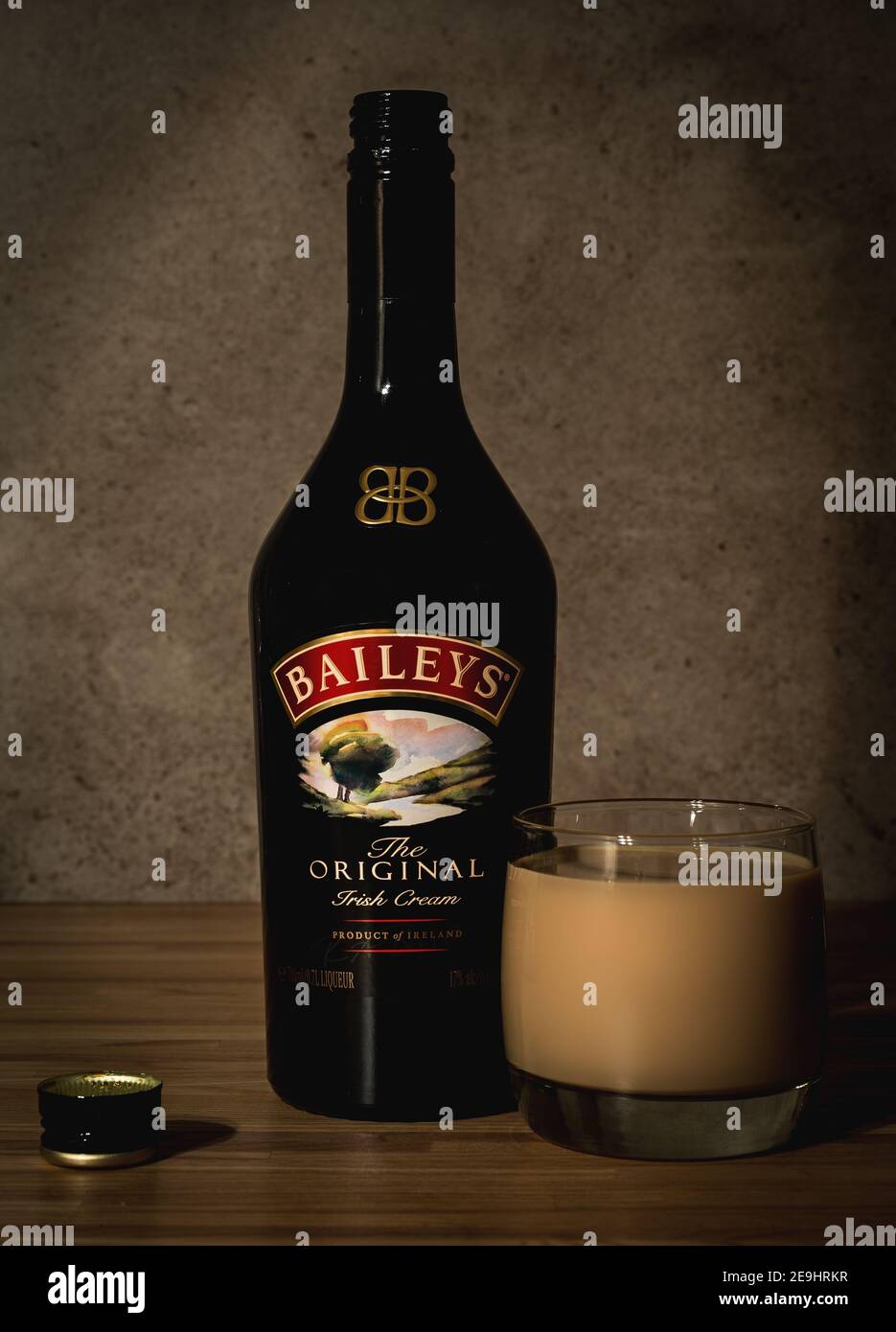 Baileys liquor open bottle with filled glass standing in bar Stock Photo