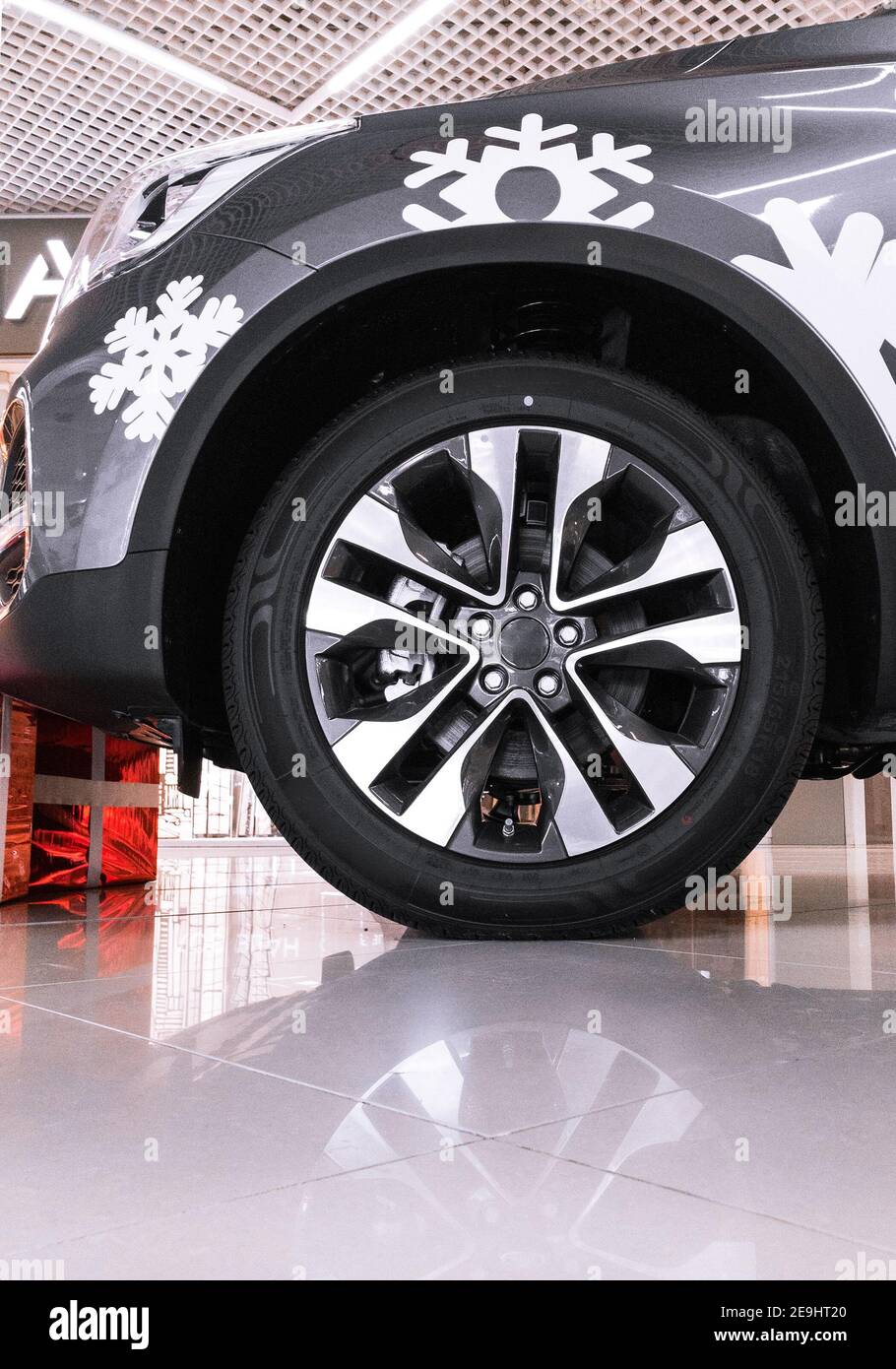 new car with its snowflake aerography and gift boxes at dealer center Stock Photo
