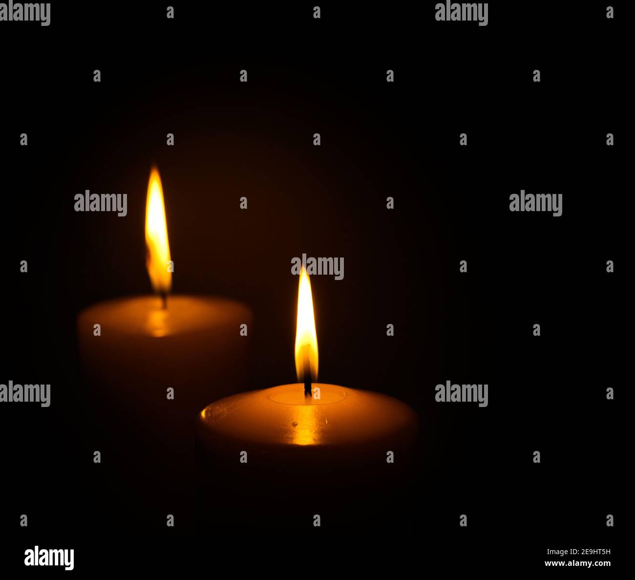 two candles burning in dark Stock Photo Alamy