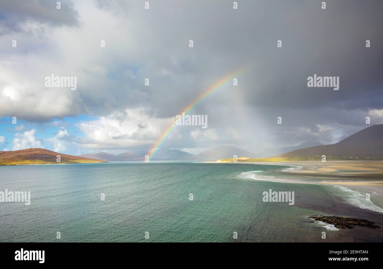 Isle of Lewis and Harris, Scotland: Rainbow and storm clouds over the large sand bay and waters of Luskentyre beach on South Harris Island Stock Photo