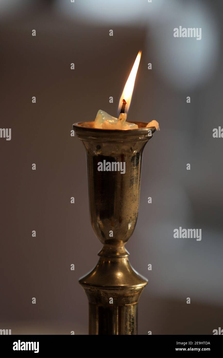 A burned out candle on a candlestick in a church Stock Photo Alamy
