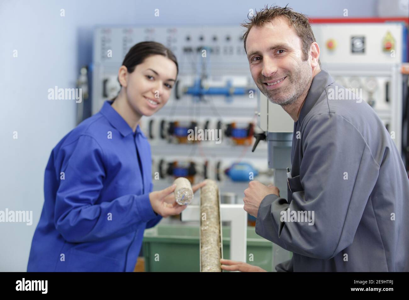 apprentice working with engineer on cnc machinery Stock Photo
