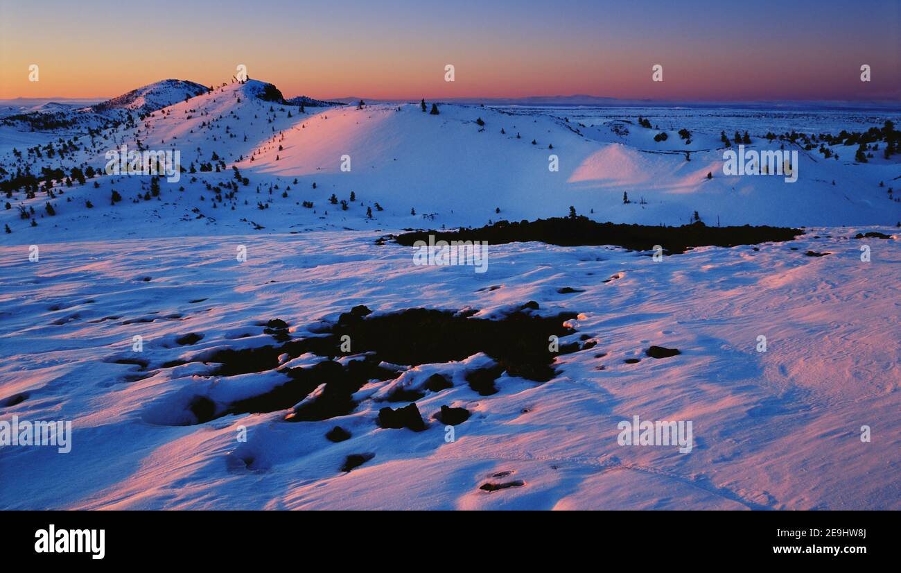 Winter sunrise from atop North Crater with Snow Cone and Spatter Cones in the background. Stock Photo