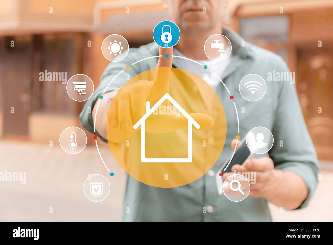 Man using application of smart home automation outdoors Stock Photo
