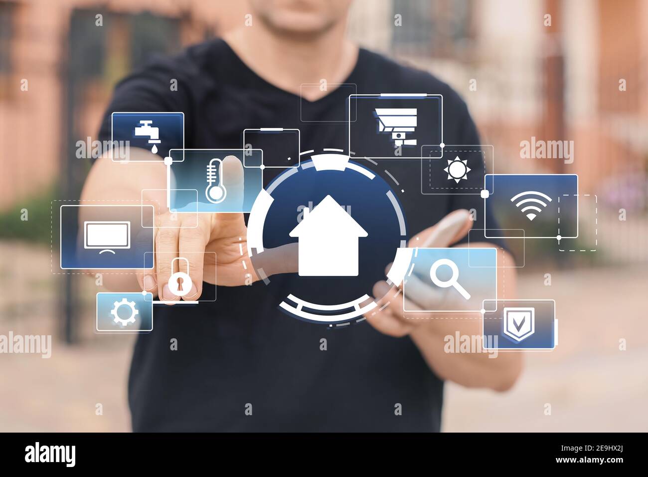 Man using application of smart home automation outdoors Stock Photo