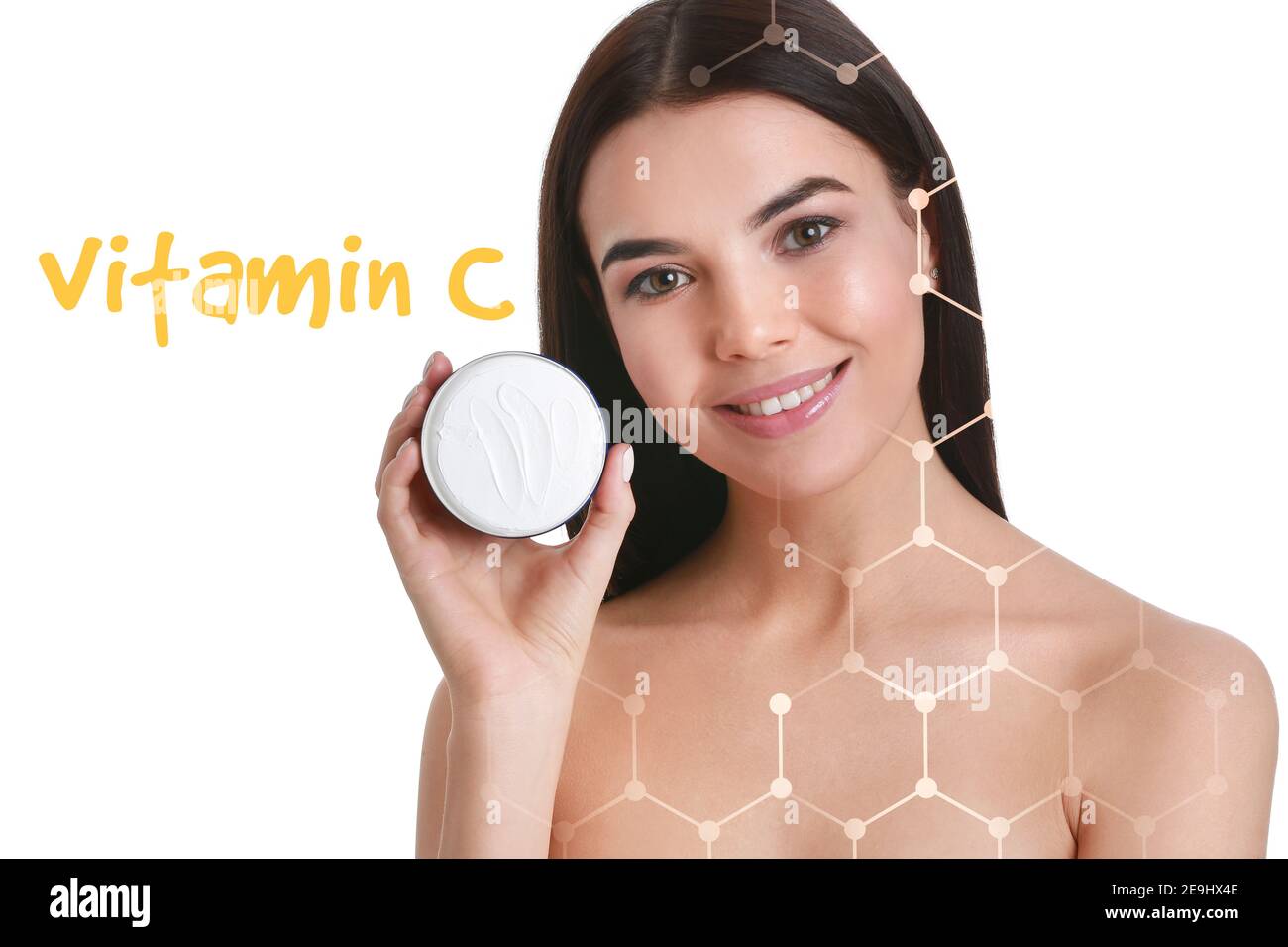Beautiful young woman holding cream with vitamin C on white background