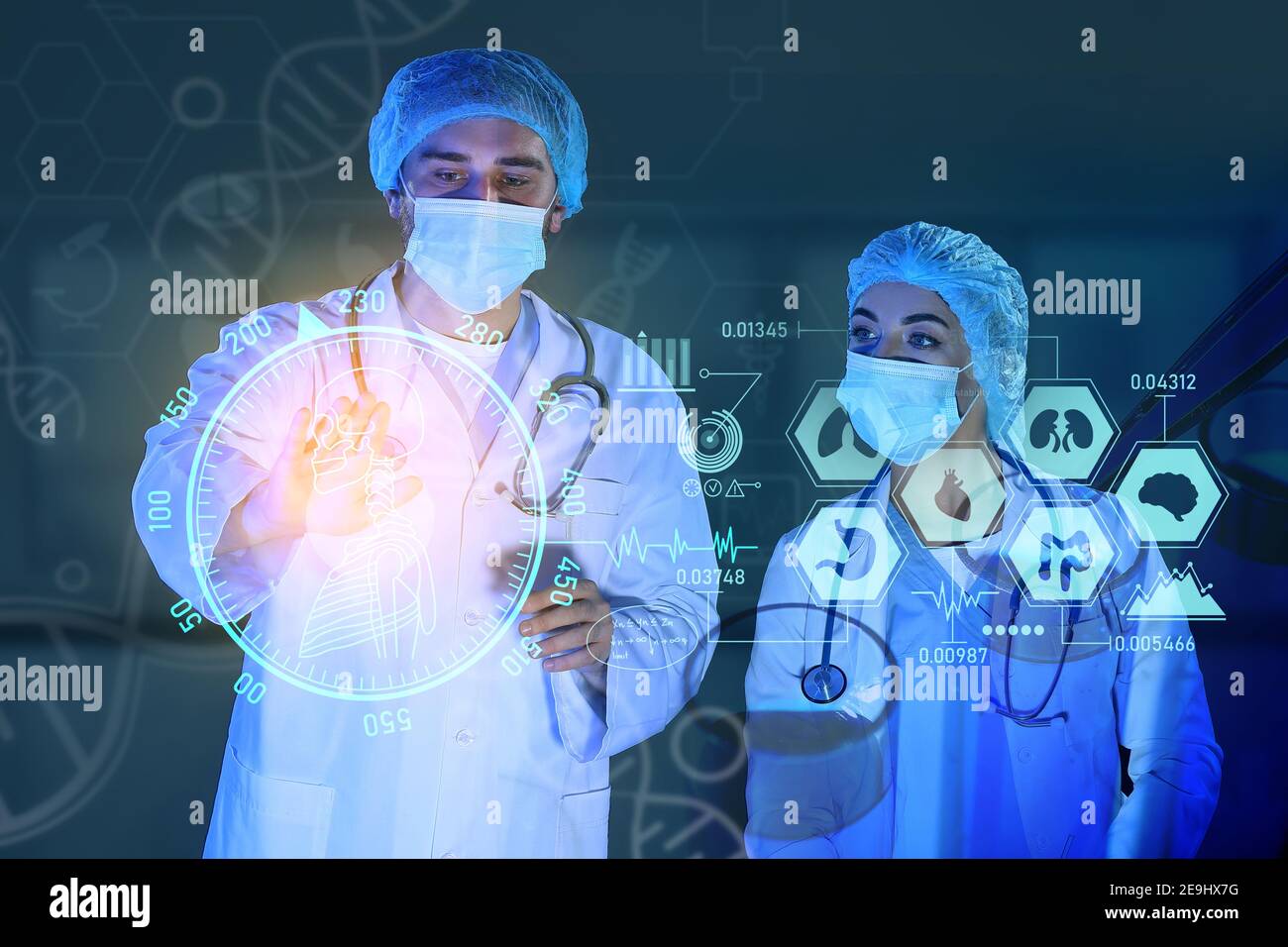 Young scientists using virtual screen on dark background Stock Photo
