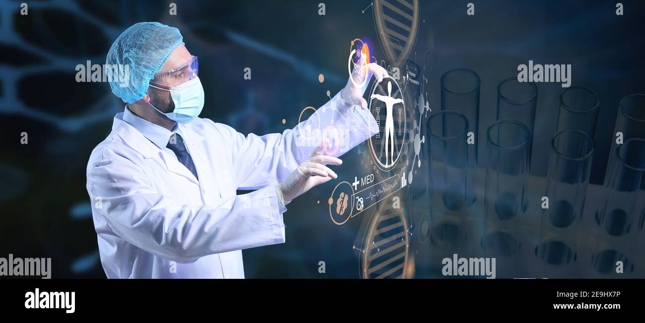 Young doctor using virtual screen on dark background Stock Photo