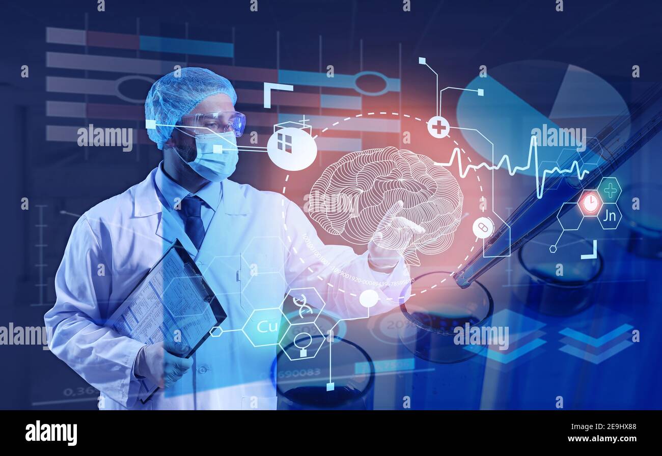 Young doctor using virtual screen on dark background Stock Photo