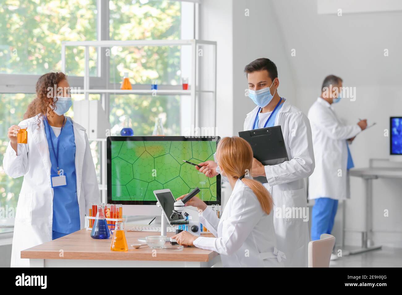 Group of scientists working in laboratory Stock Photo