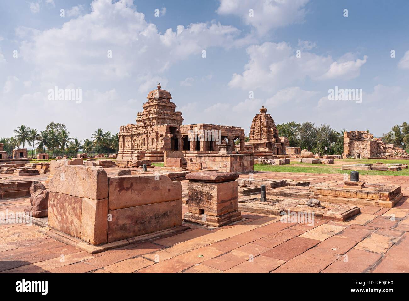Bagalakote, Karnataka, India - November 7, 2013: Pattadakal temple complex. View over brown stone ruimous temple buildings under blue cloudscape. Belt Stock Photo