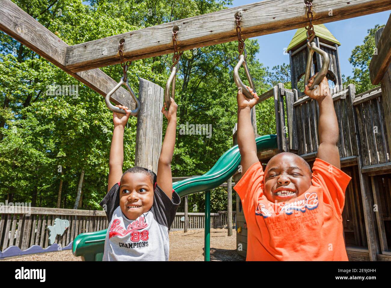 Alabama Alexander City Charles Bailey Sportplex,playground children Black boys kids hanging swinging, Stock Photo
