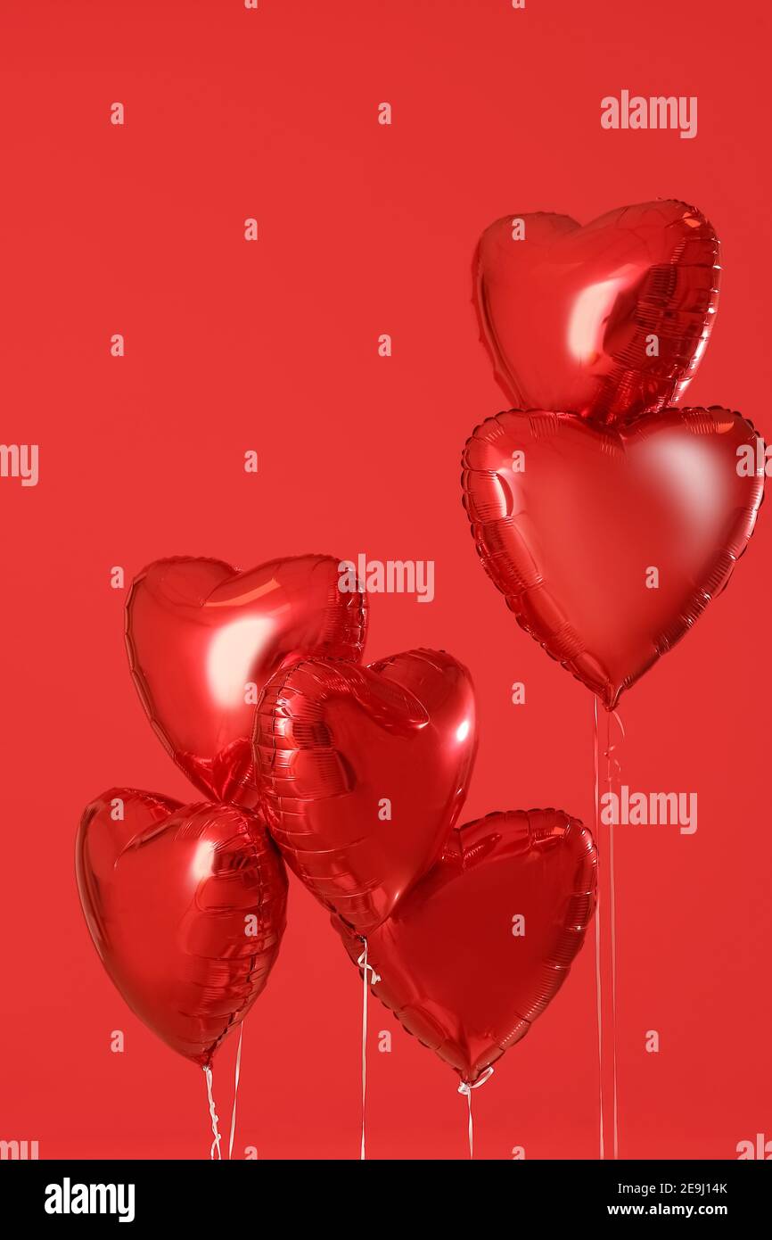 Heart shaped air balloons on color background Stock Photo - Alamy