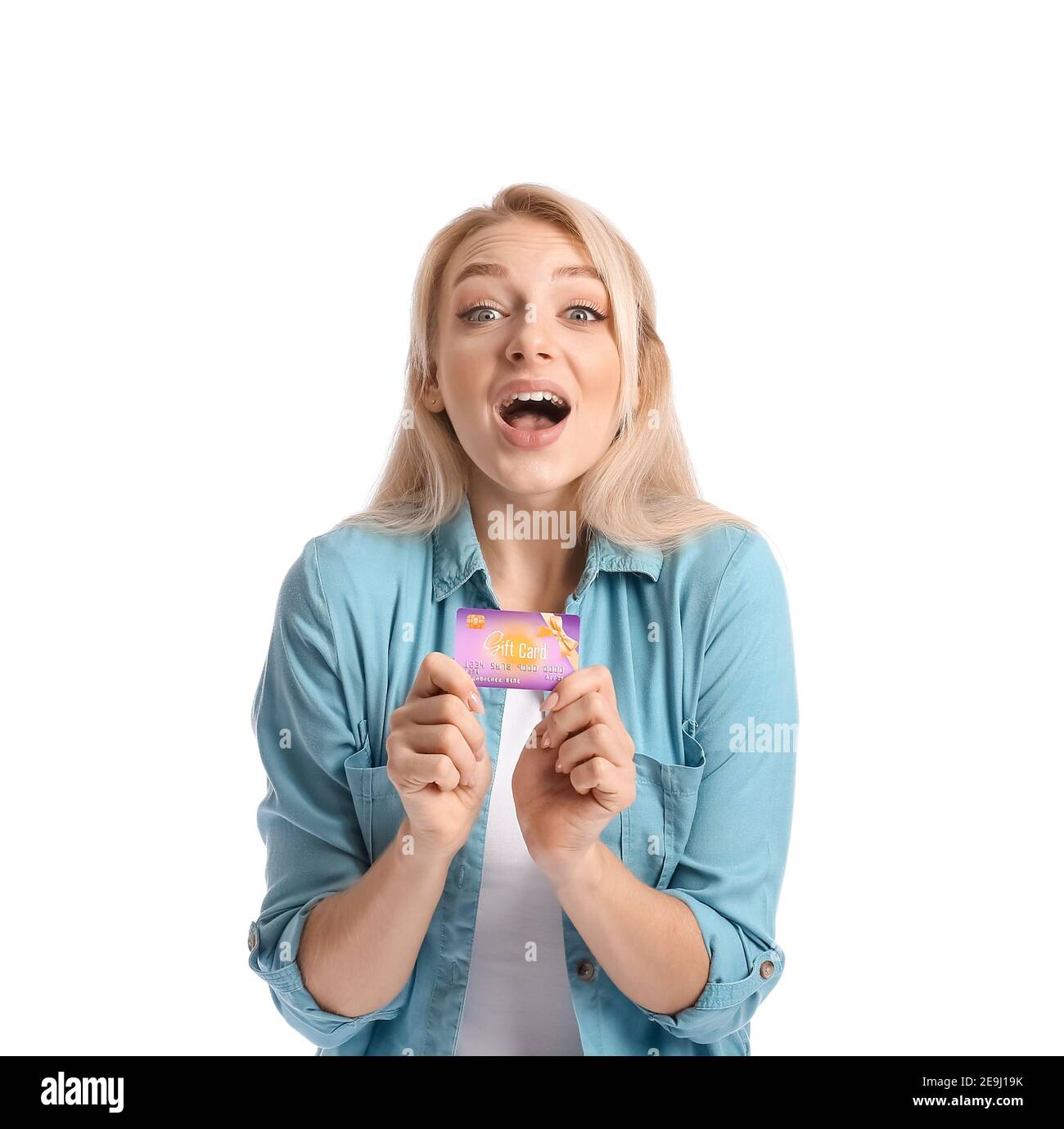 Surprised young woman with gift card on white background Stock Photo ...